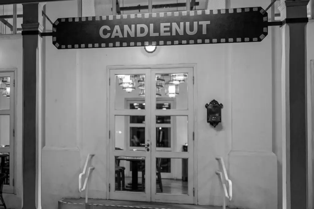 Candlenut restaurant entrance with decorative sign above glass doors at Dempsey
