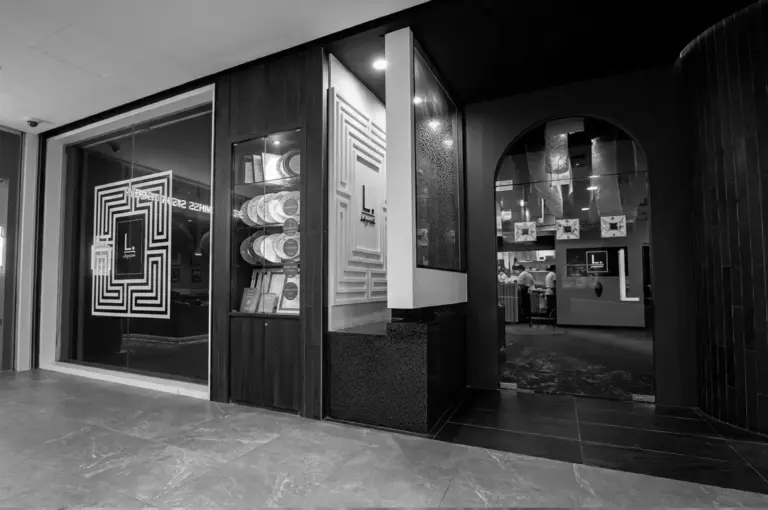 Labyrinth restaurant entrance with maze logo on glass, award display, and arched doorway to kitchen