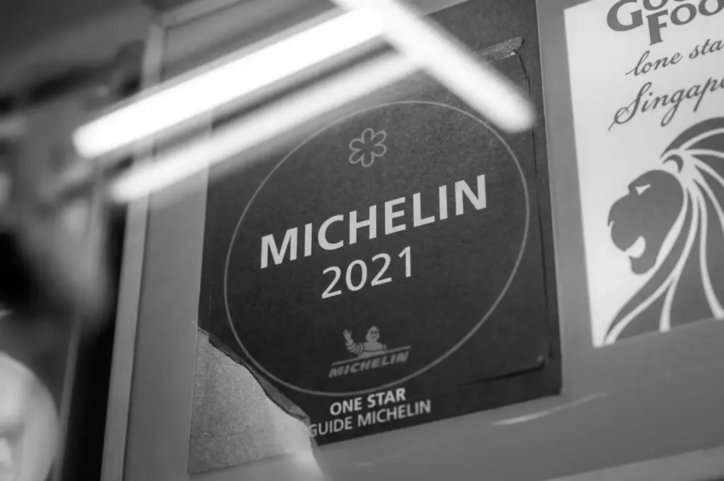 Black and white close-up of a Michelin Guide 2021 One Star award sticker on a window