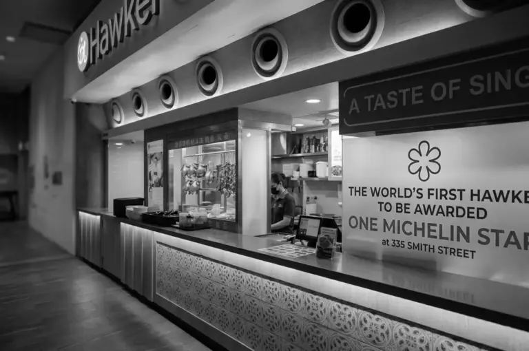 Modern hawker stall counter with Michelin star award signage at 335 Smith Street