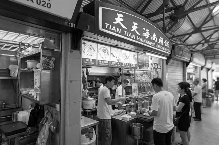 Tian Tian Hainanese Chicken Rice stall counter with staff preparing food and customers queueing at the famous Singapore food stall