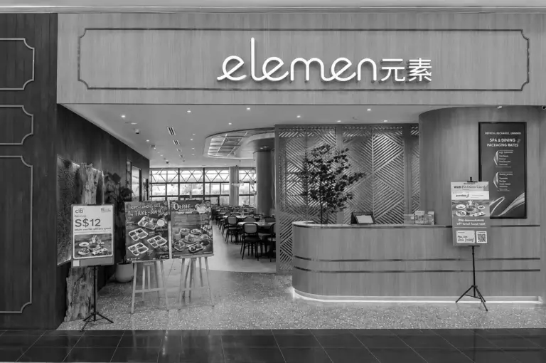 Elemen restaurant entrance with modern wood design and promotional menu boards outside