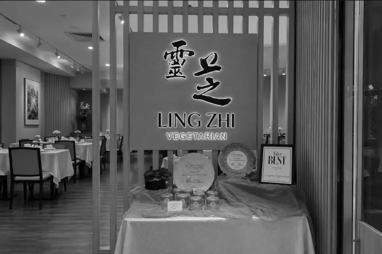 Ling Zhi Vegetarian restaurant entrance with illuminated sign and awards on display table