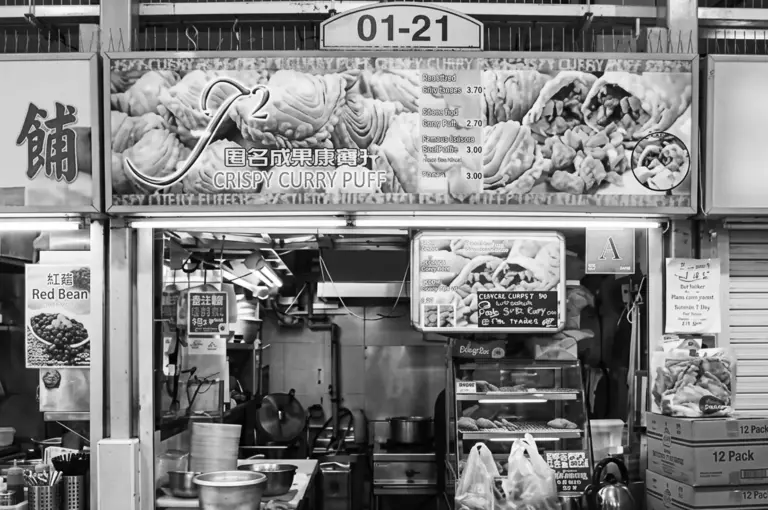 Price: $ Hong Lim Market is home to some incredible South Asian food and hawker classics, but Outram Park Fried Kway Teow Mee is the undeniable star. In our experience, finding a perfectly balanced char kway teow is tough, but this stall masters it. They fry their flat rice noodles in a dark, sweet, and savory sauce that caramelizes beautifully in the wok, creating the coveted wok hei flavor. We loved the rich, eggy texture of the noodles and the intense wok hei (breath of the wok) that permeates every bite. The dish is typically served with bean sprouts and cockles, which add a wonderful burst of brine. Just be prepared; the queue here is practically a permanent fixture. Good News for: Early birds looking for a hearty hawker breakfast or die-hard old-school noodle lovers. Bad News if: You prefer your lunch on the lighter side (this dish is delightfully oily and rich). 4. J2 Famous Crispy Curry Puff (Amoy Street Food Centre) – The Ultimate Street Food Snack