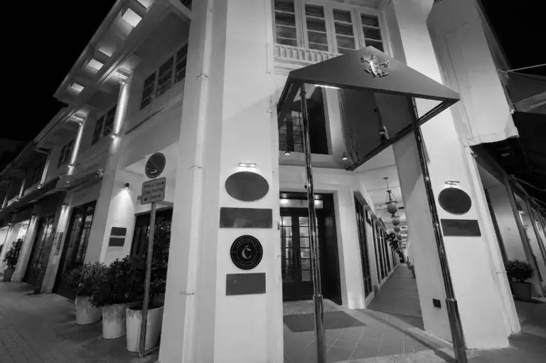Cultivate Café entrance at night with modern canopy and heritage architecture