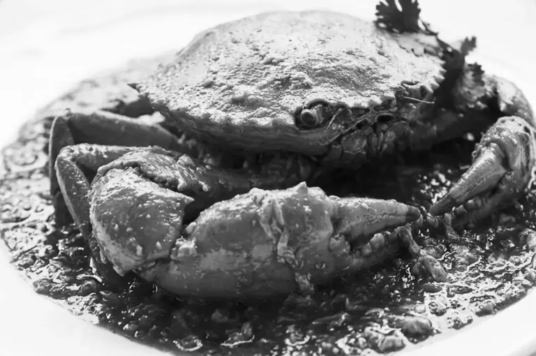Whole crab dish in rich sauce, Michelin-starred hawker specialty