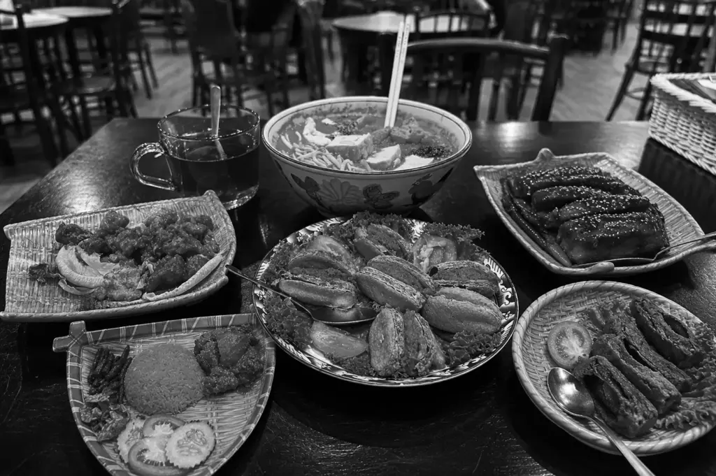 Table spread of Asian dishes including noodle soup