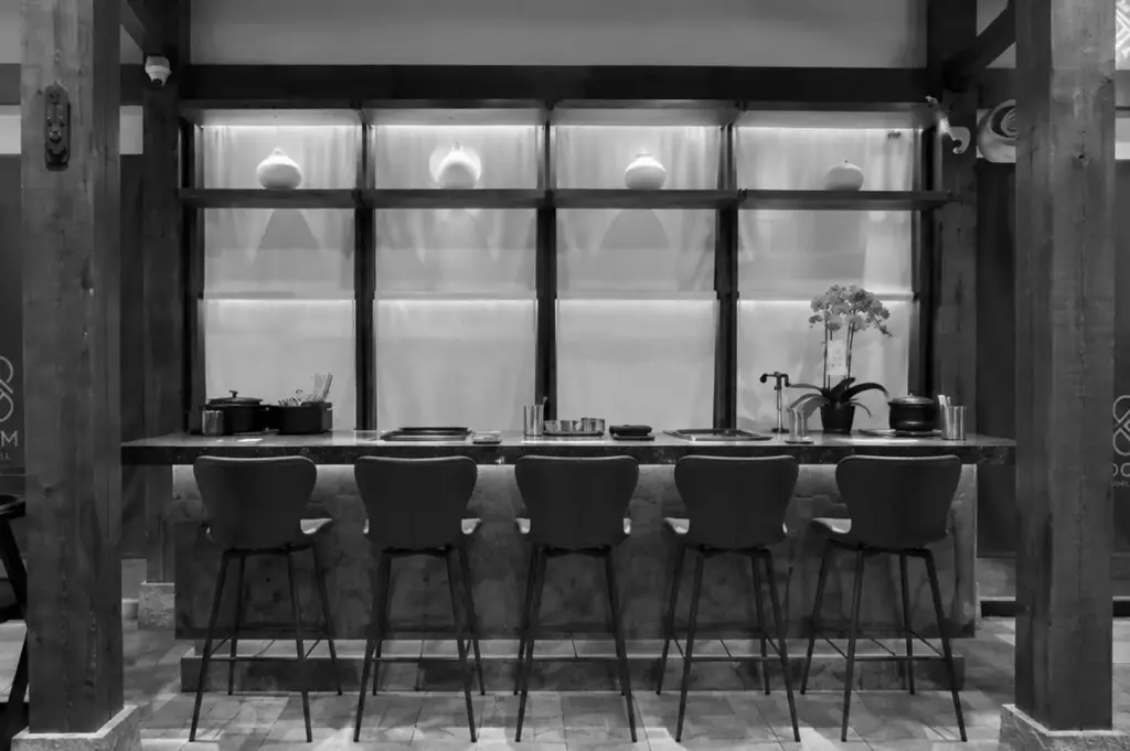 Modern Korean BBQ counter seating with minimalist rustic interior design