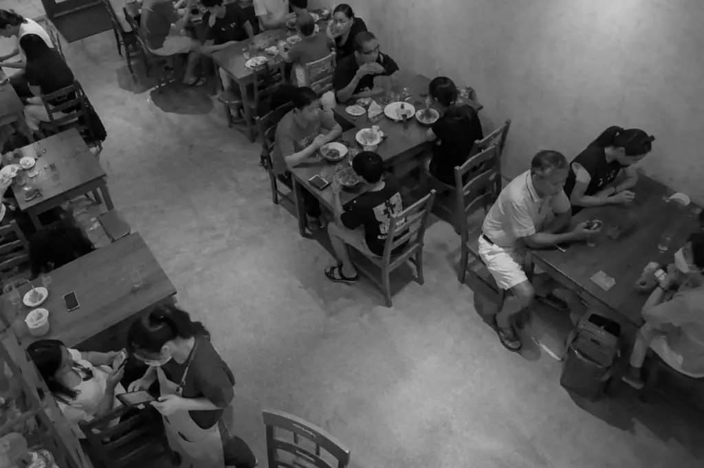 Diners enjoying vegetarian meals inside Lucky Cat Cafe at Hougang Community Club