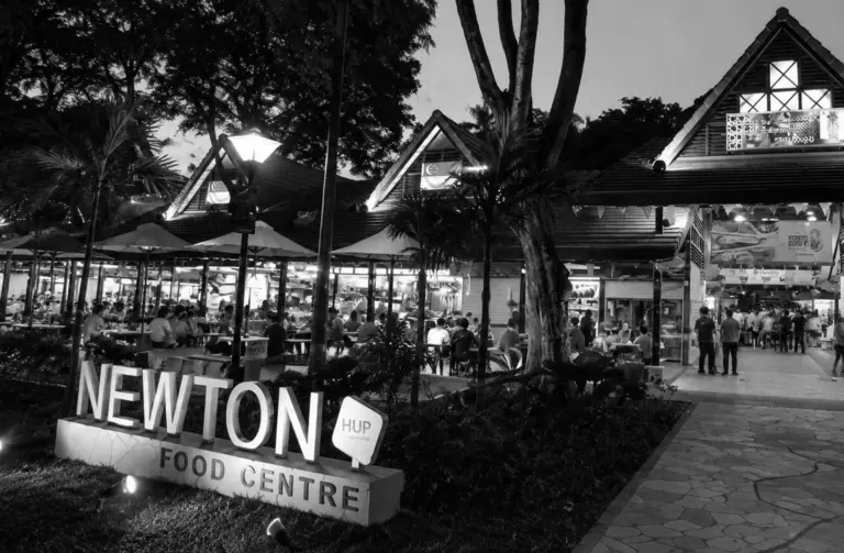 Exterior view of Newton Food Centre illuminated at night.