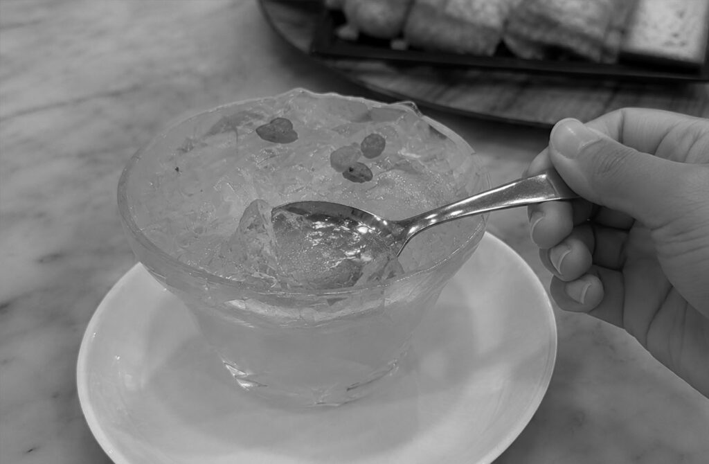 A solo diner enjoys a chilled dessert during a meal in Singapore