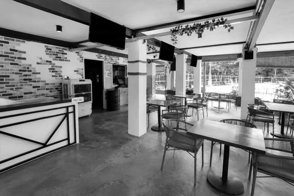 Spacious indoor dining area at The Summerhouse Singapore with modern tables and large windows.