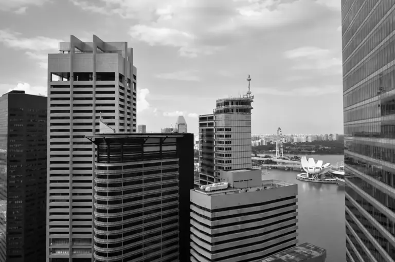 View of Republic Plaza Singapore skyline overlooking Marina Bay on a cloudy day.