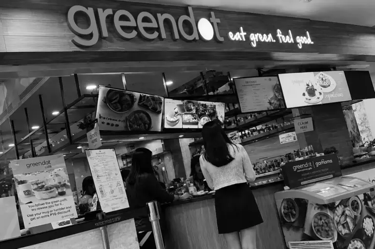 Greendot restaurant storefront with customers ordering at the counter in a shopping mall.