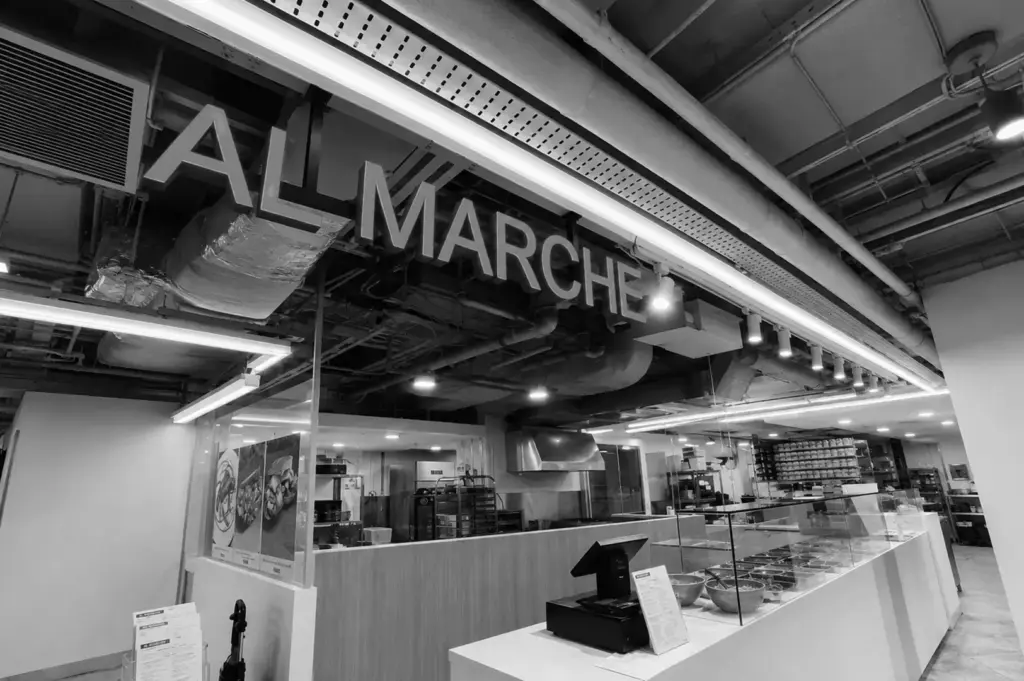 All Marche open kitchen counter with fresh ingredients and preparation area.
