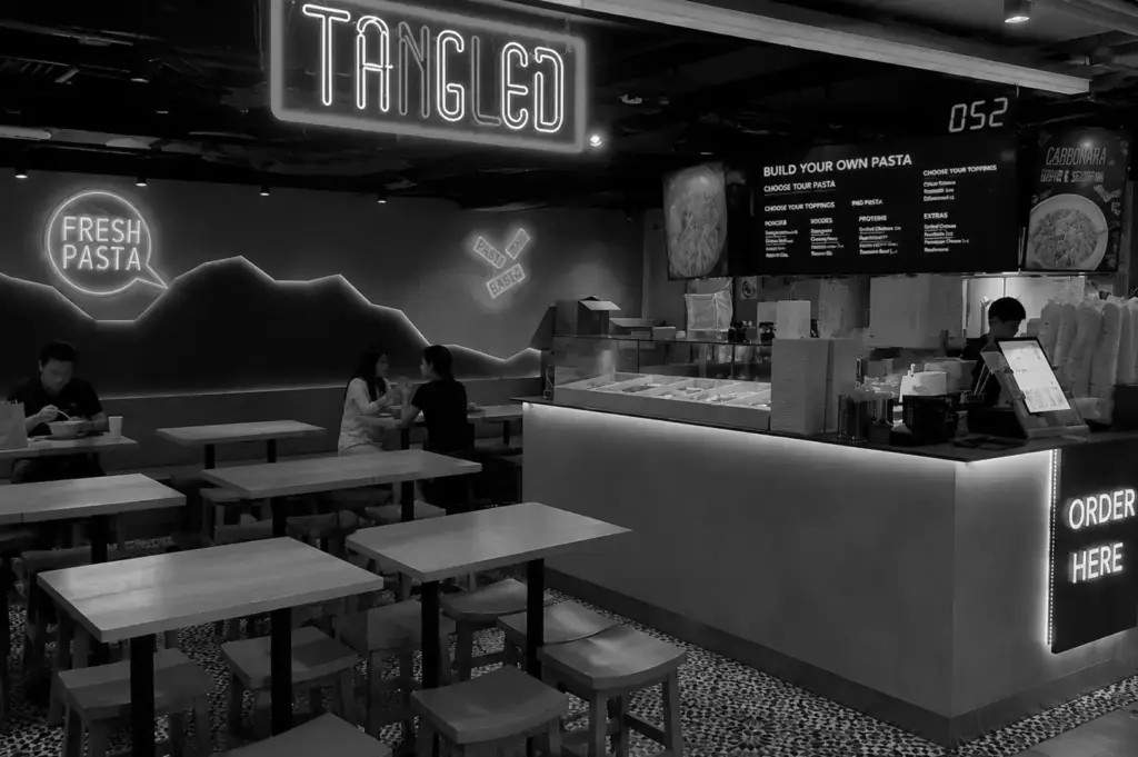 Tangled pasta restaurant counter with fresh pasta menu and ordering station.