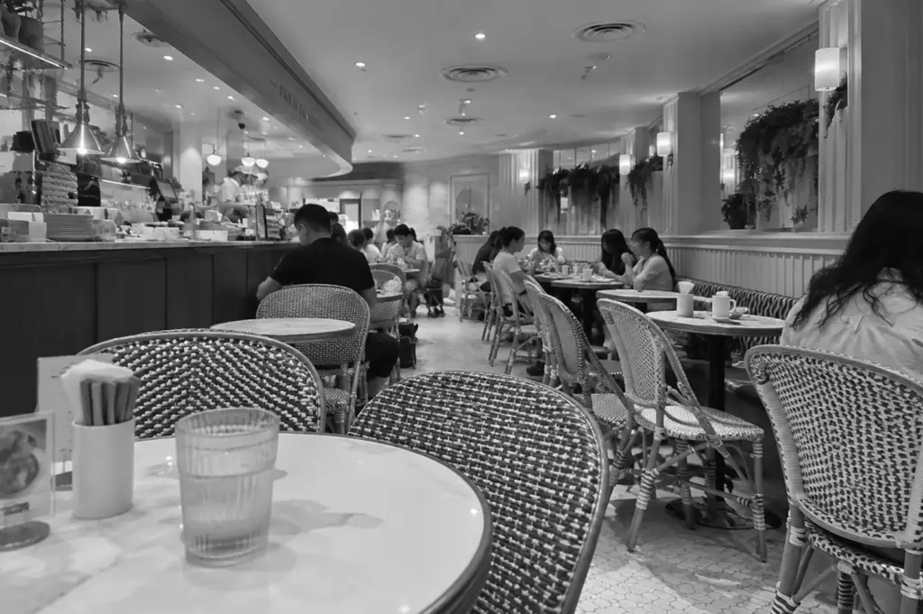 Busy restaurant dining area in Singapore, with diners gathered around tables in a casual setting.