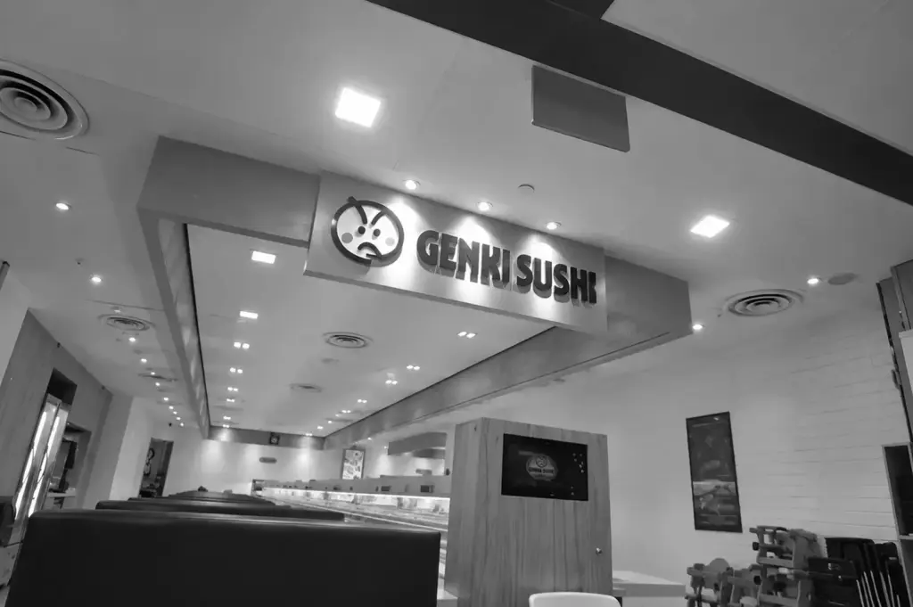 Genki Sushi Chinatown Point storefront and dining area with the Genki Sushi sign prominently displayed.